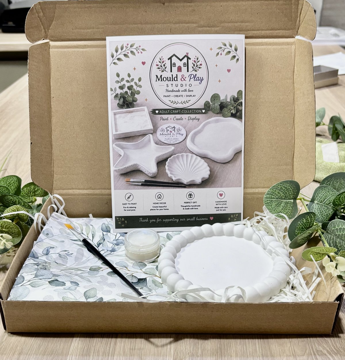 Adult decoupage box open, showing the plaster tray, decoupage paper, brush and Mod Podge